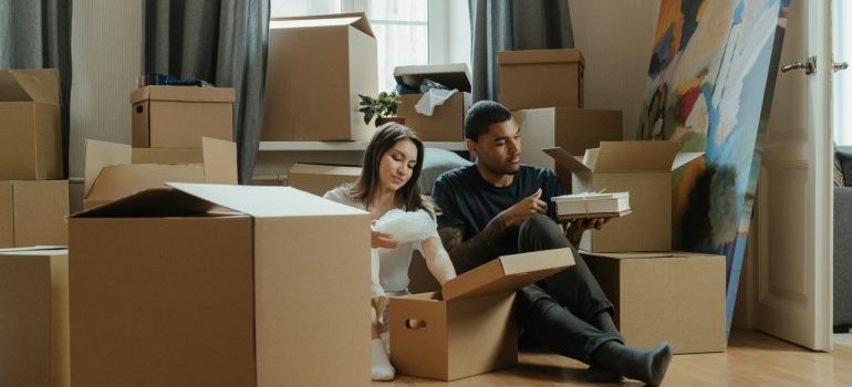 Couple surrounded by moving boxes